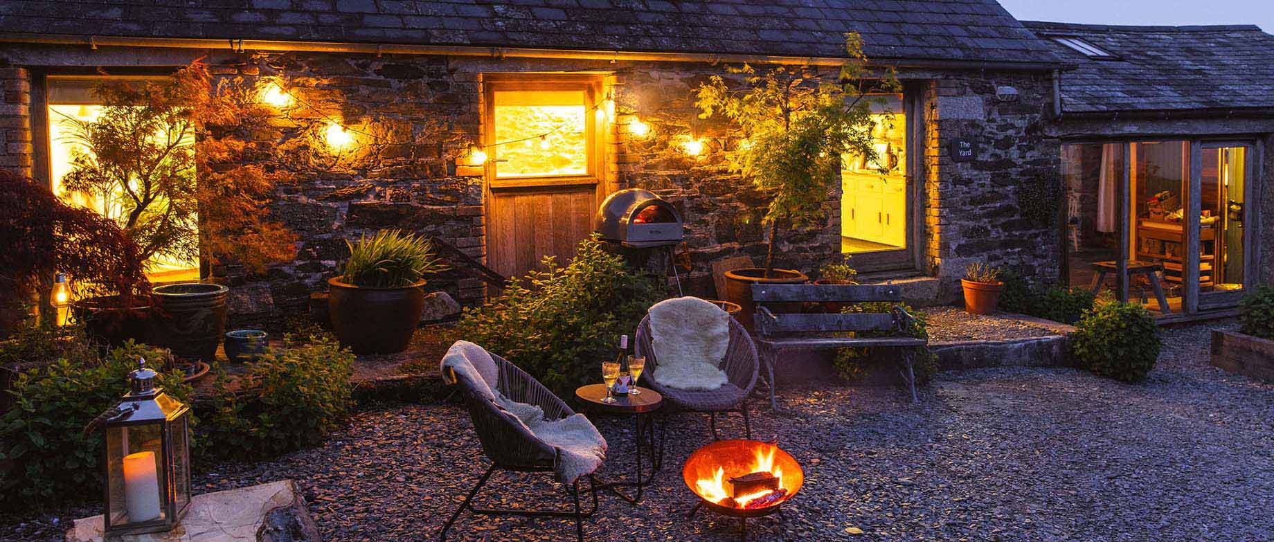 Borough Farm at night with candles, log fire and pizza oven