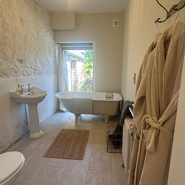 The shippon bathroom with antique roll top bath