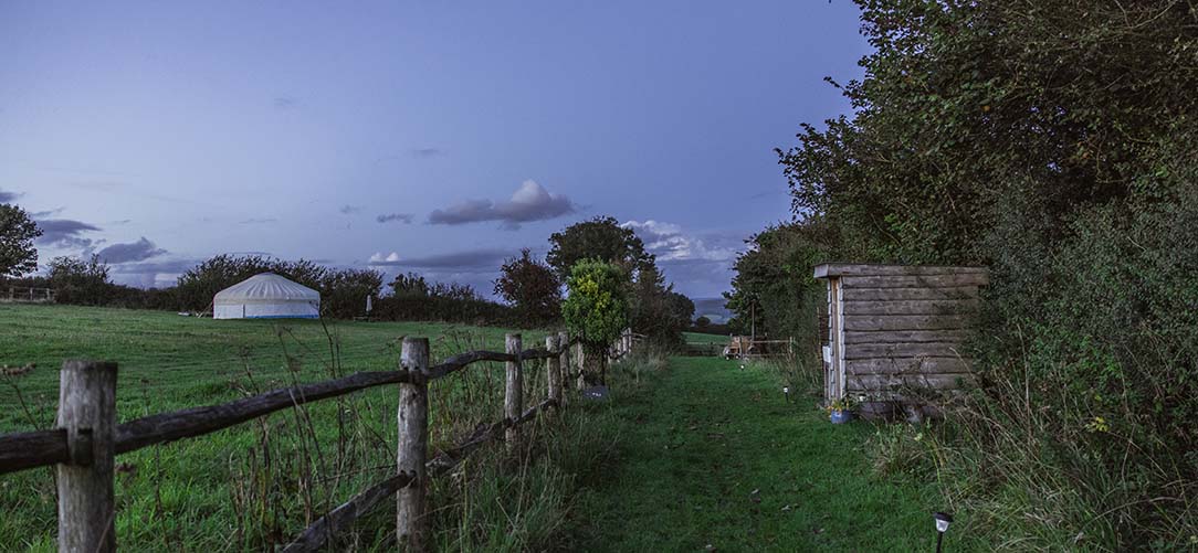 View across the field to Great Links Yurt at dawn